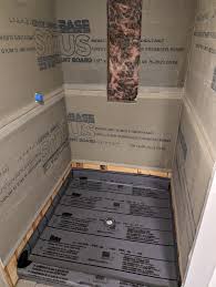 Old wet bed vinyl pan liner system installed in shower stall showing the traditional waterproofing method