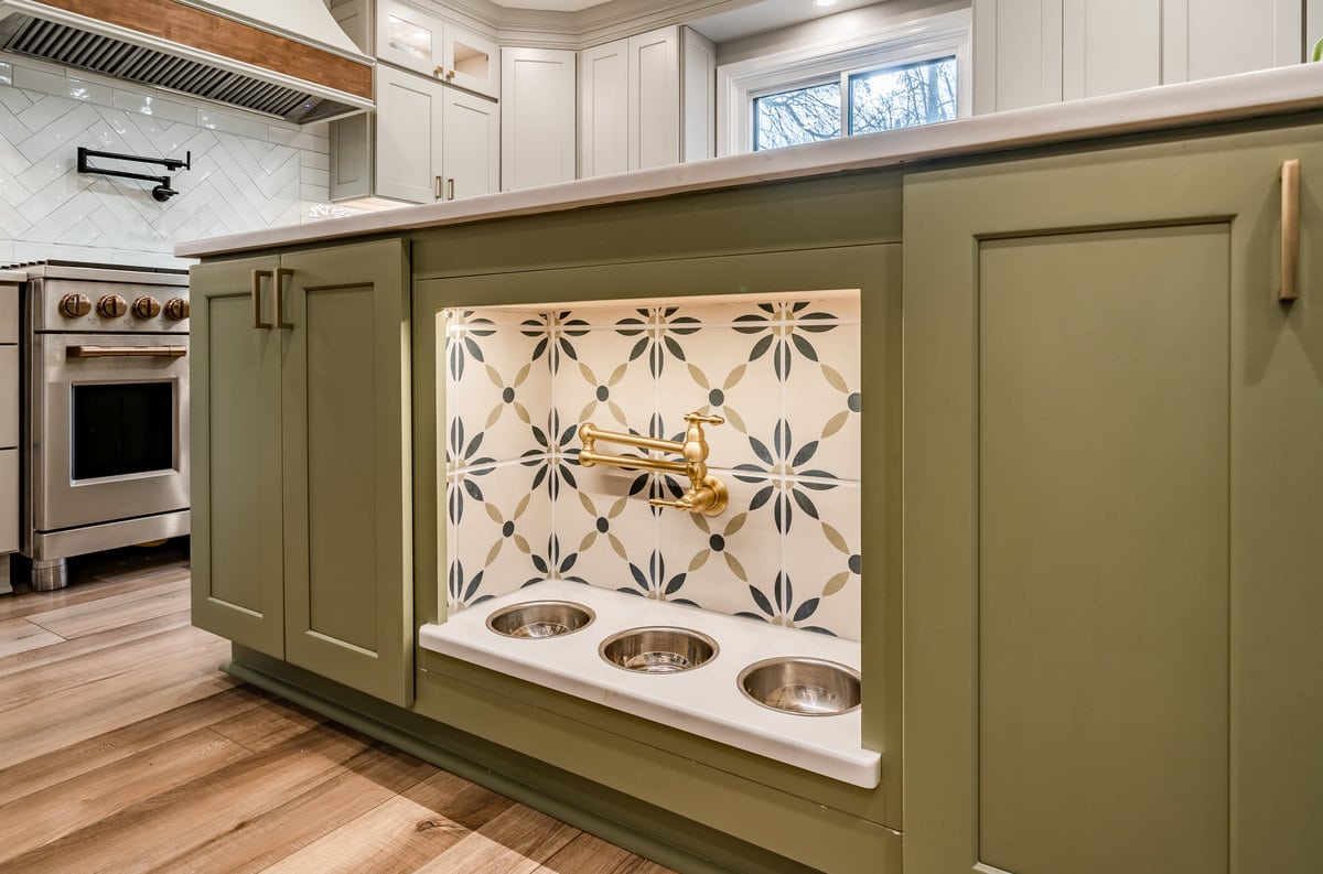 Glenn Mills farmhouse kitchen with custom green cabinets and built-in dog bowls