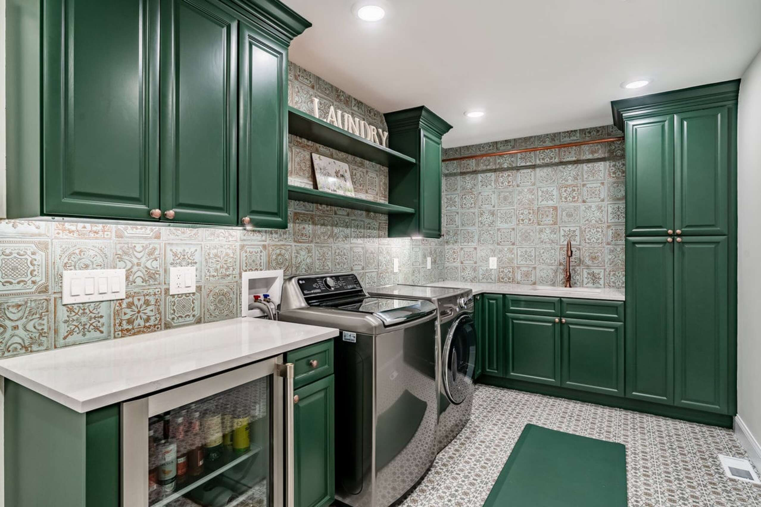 Chadds Ford laundry room green cabinets with patterned backsplash and beverage fridge