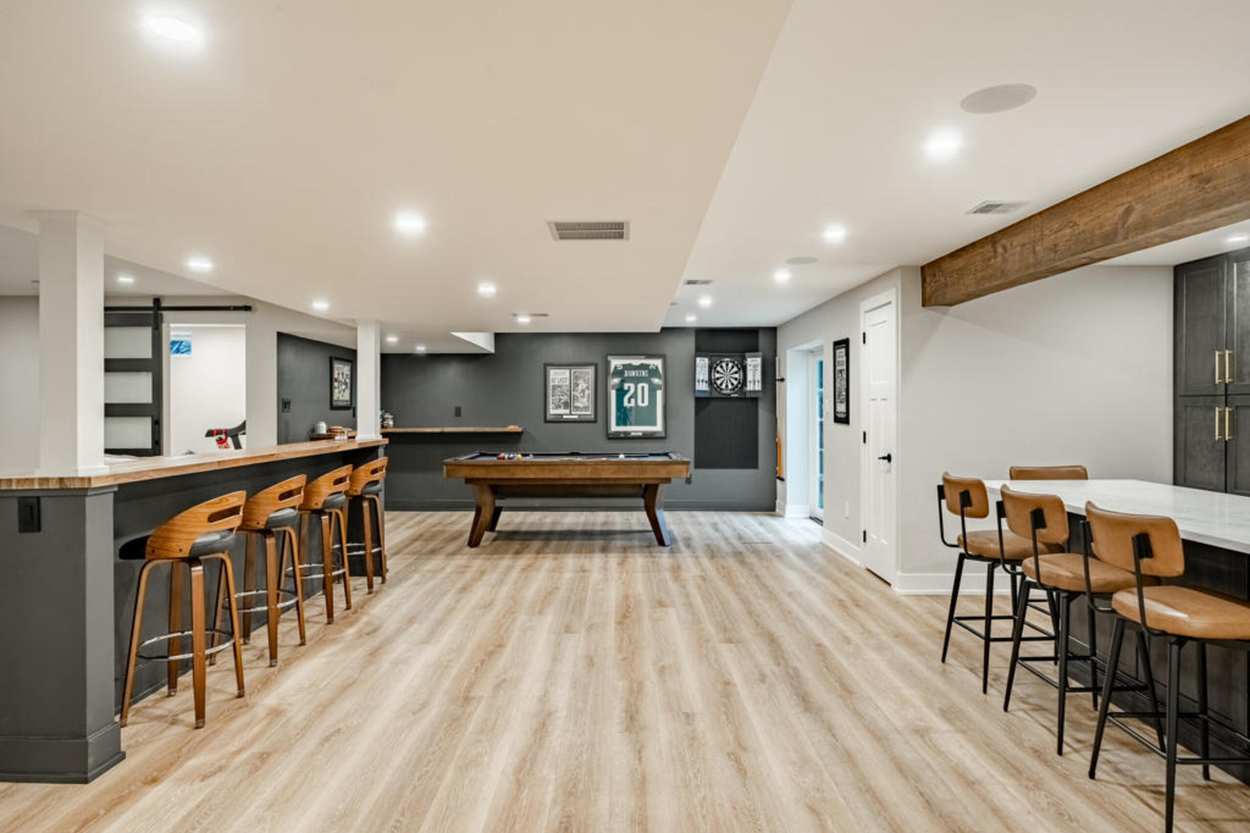 Chester Springs PA basement remodel with custom wet bar, pool table game room, charcoal cabinetry, and reclaimed barn wood beam