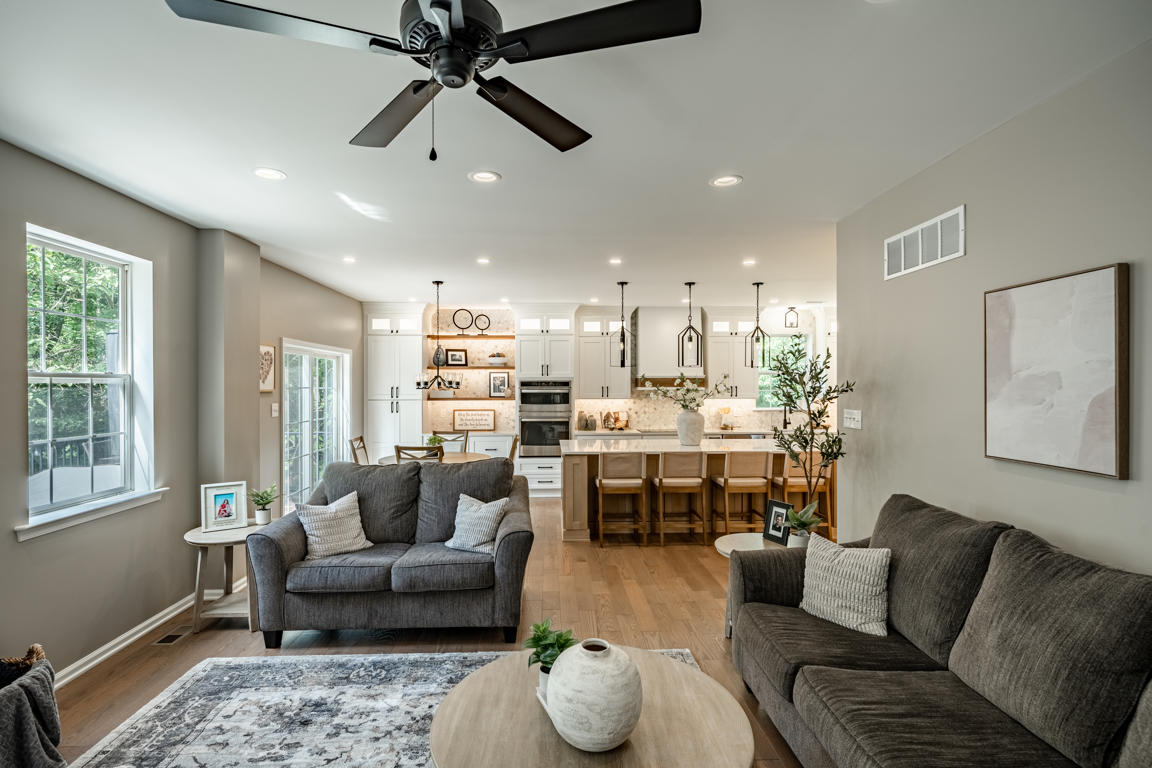 Natural white oak island base cabinet detail showing honey-toned finish, deep drawers with oversized matte black pulls, and quartz countertop edge