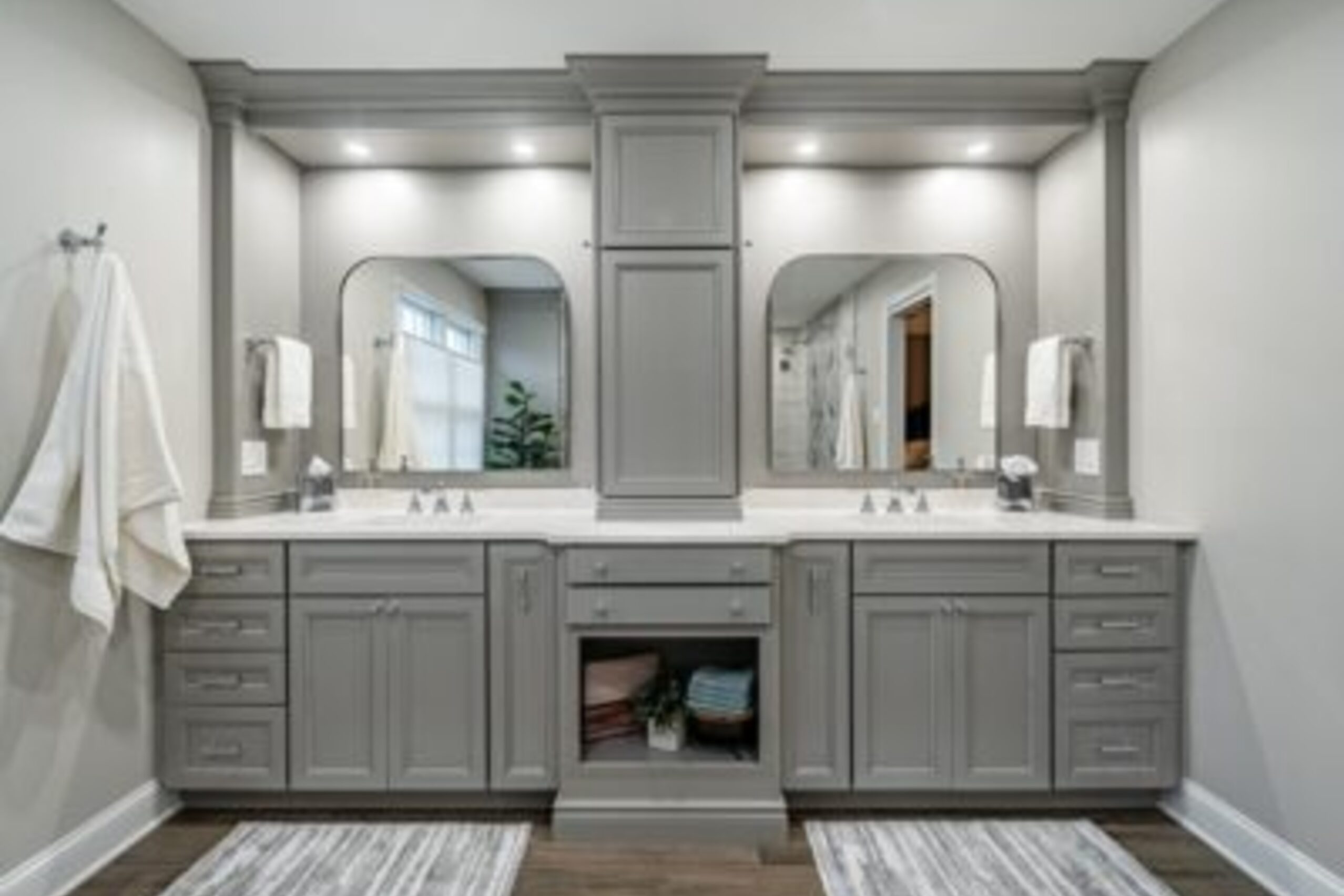 Downingtown bathroom gray double vanity with arched mirrors, center tower cabinet, and quartz countertops