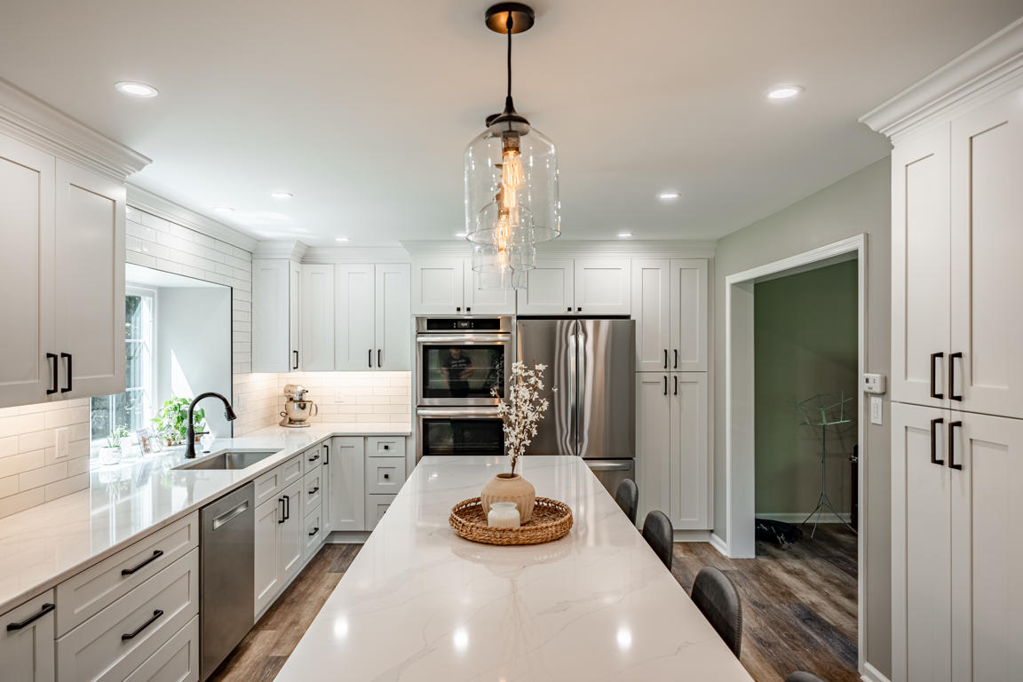 Kitchen with island seating, pendant lights, and stainless appliances