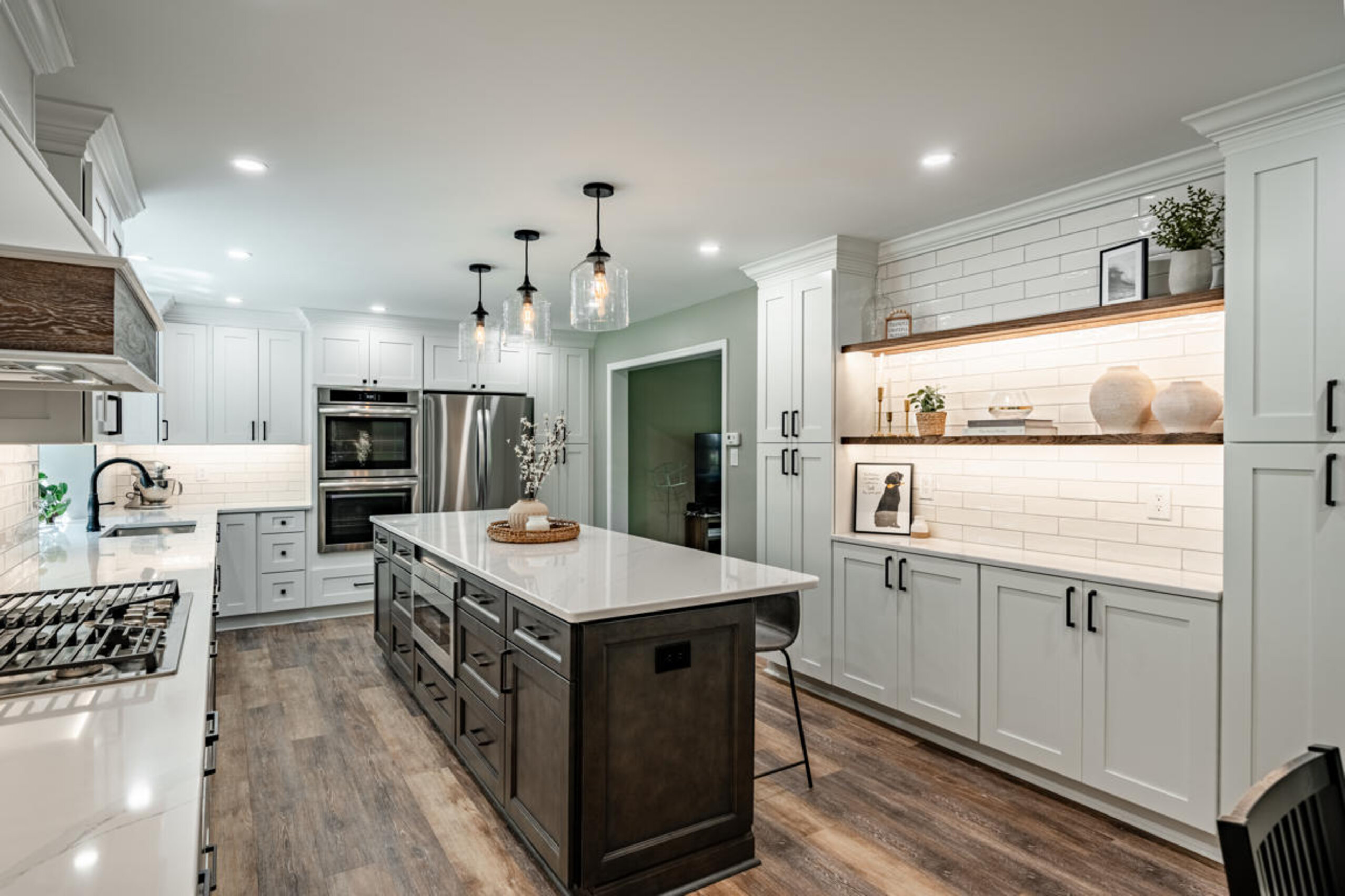 Dark walnut kitchen island with reclaimed barnwood range hood, LED-lit display niche, and subway tile backsplash