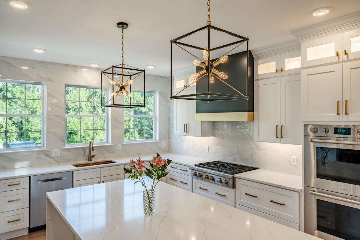 Built-in stainless steel French-door refrigerator with professional finish at end of galley run