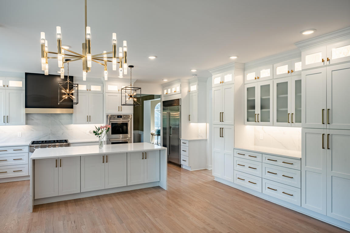 Open concept view from kitchen through to living room with hardwood floors running continuously throughout