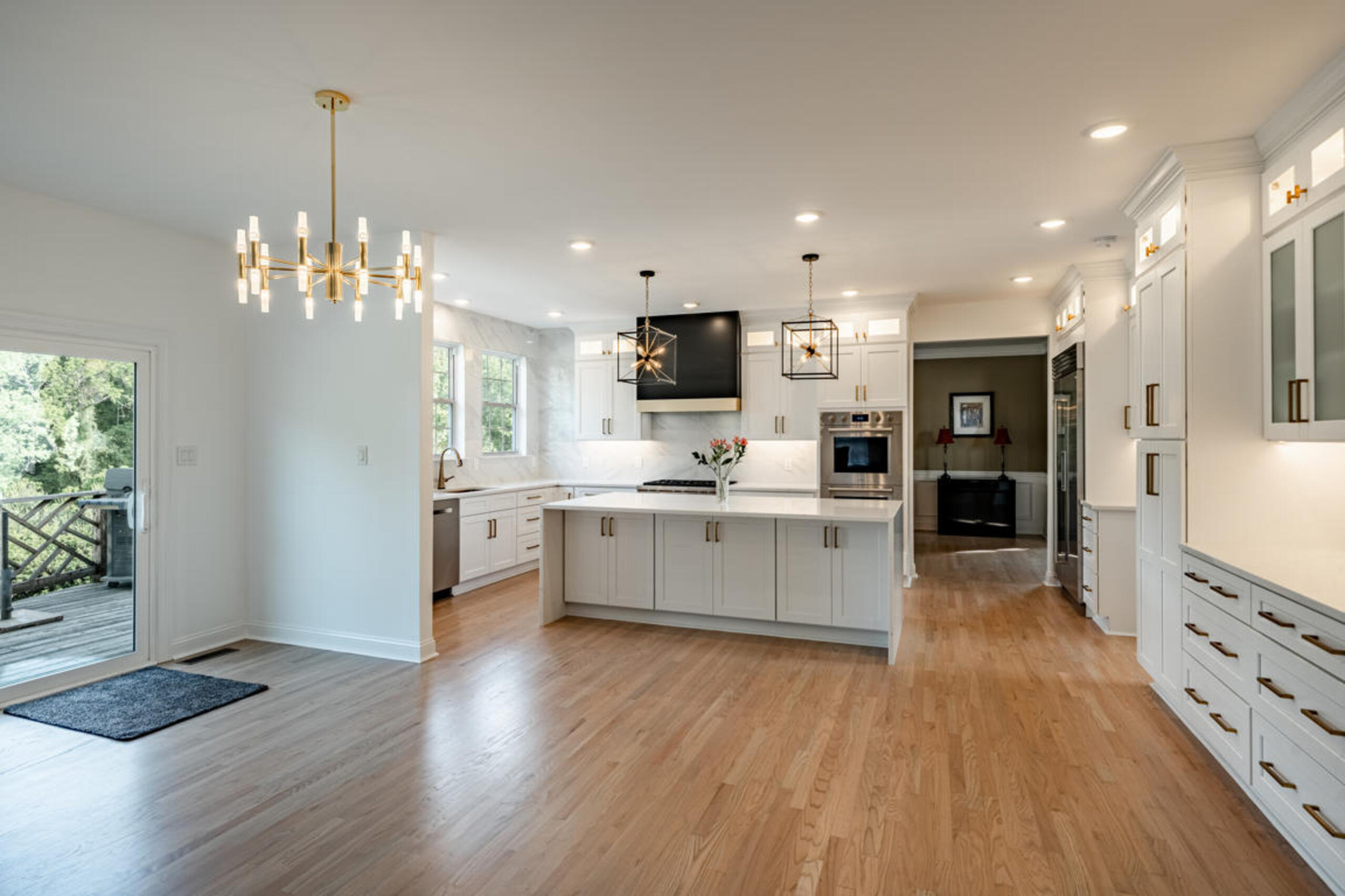 Kennett Square kitchen remodel with white shaker cabinets, brushed gold hardware, and quartz waterfall island