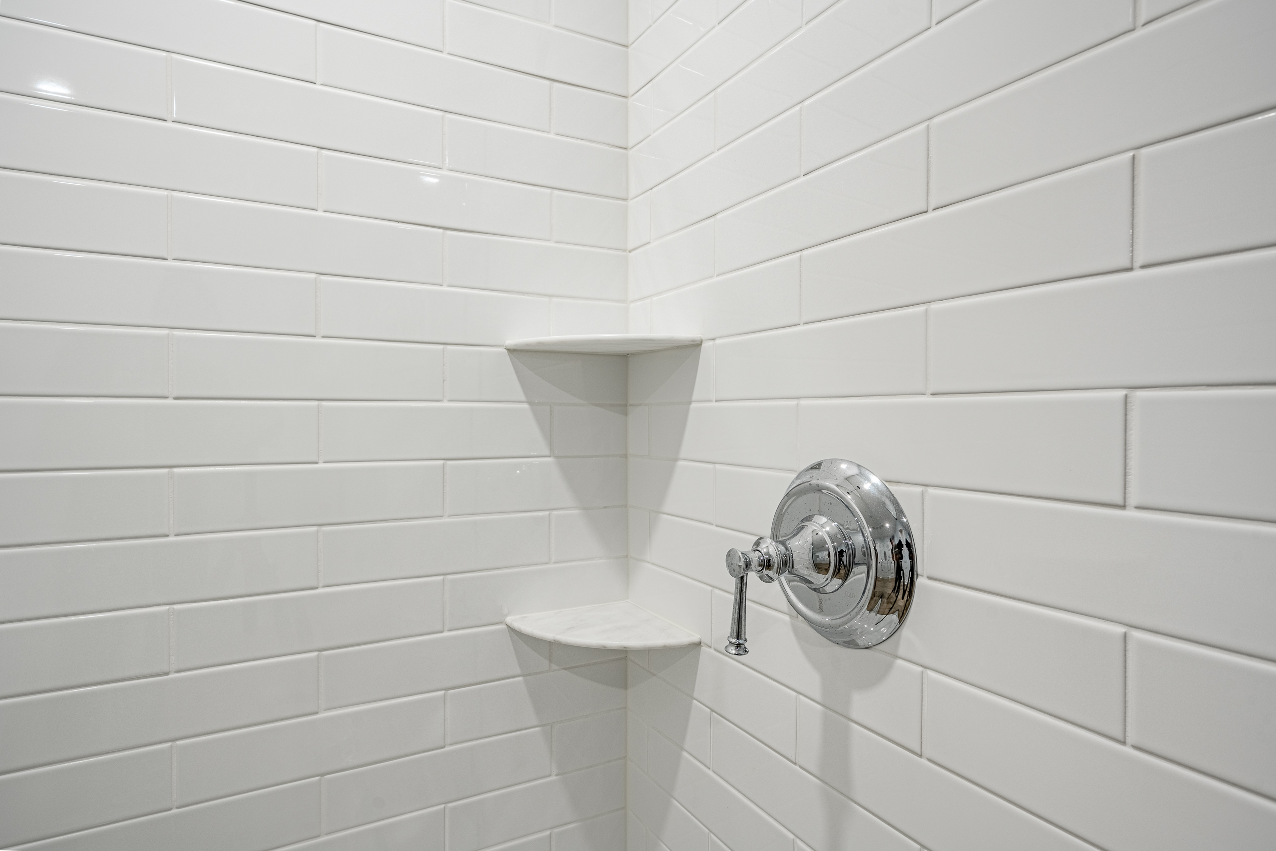 Newtown Square basement bathroom - white subway tile shower detail with chrome fixtures