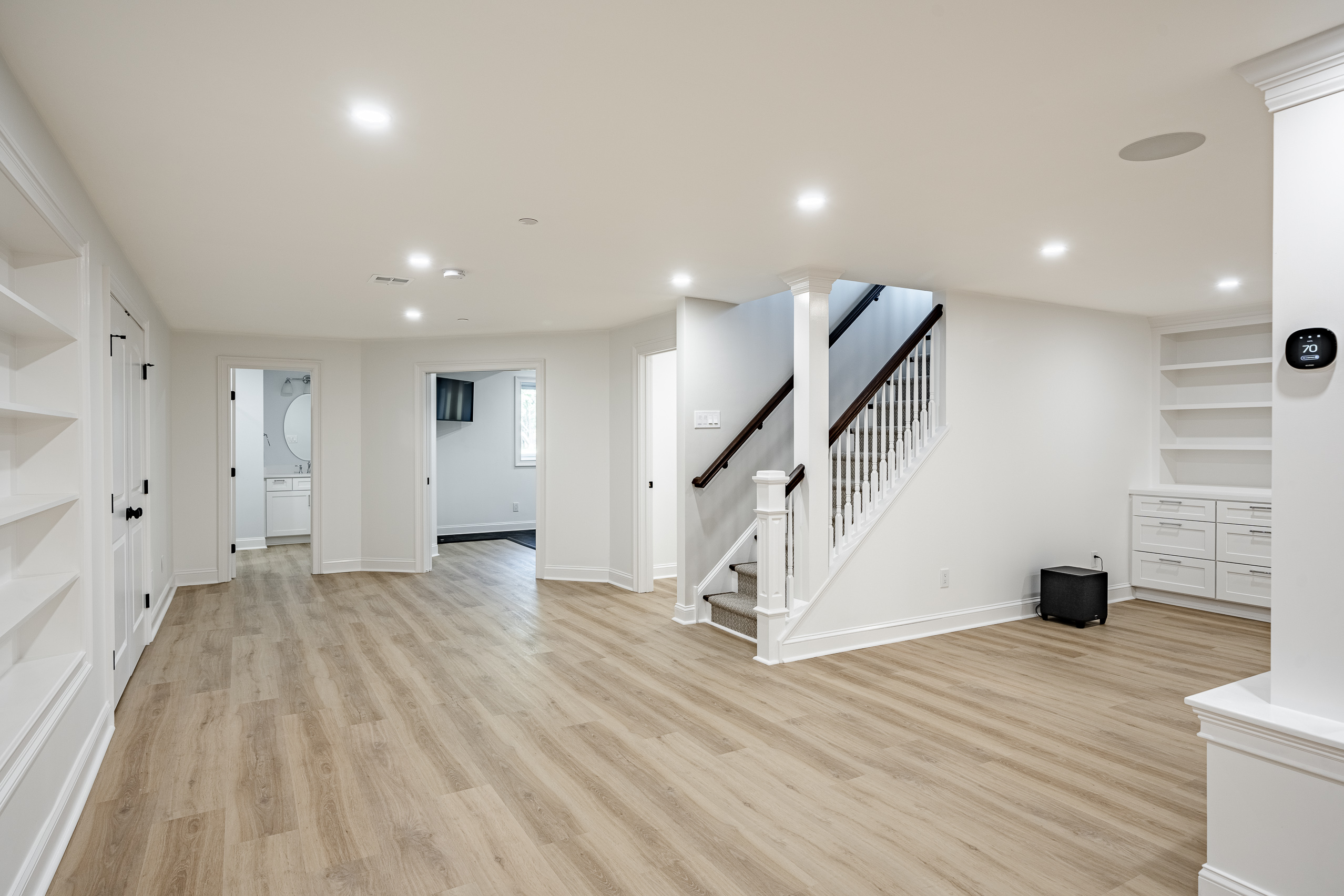 Newtown Square basement finishing - open floor plan with staircase and thermostat