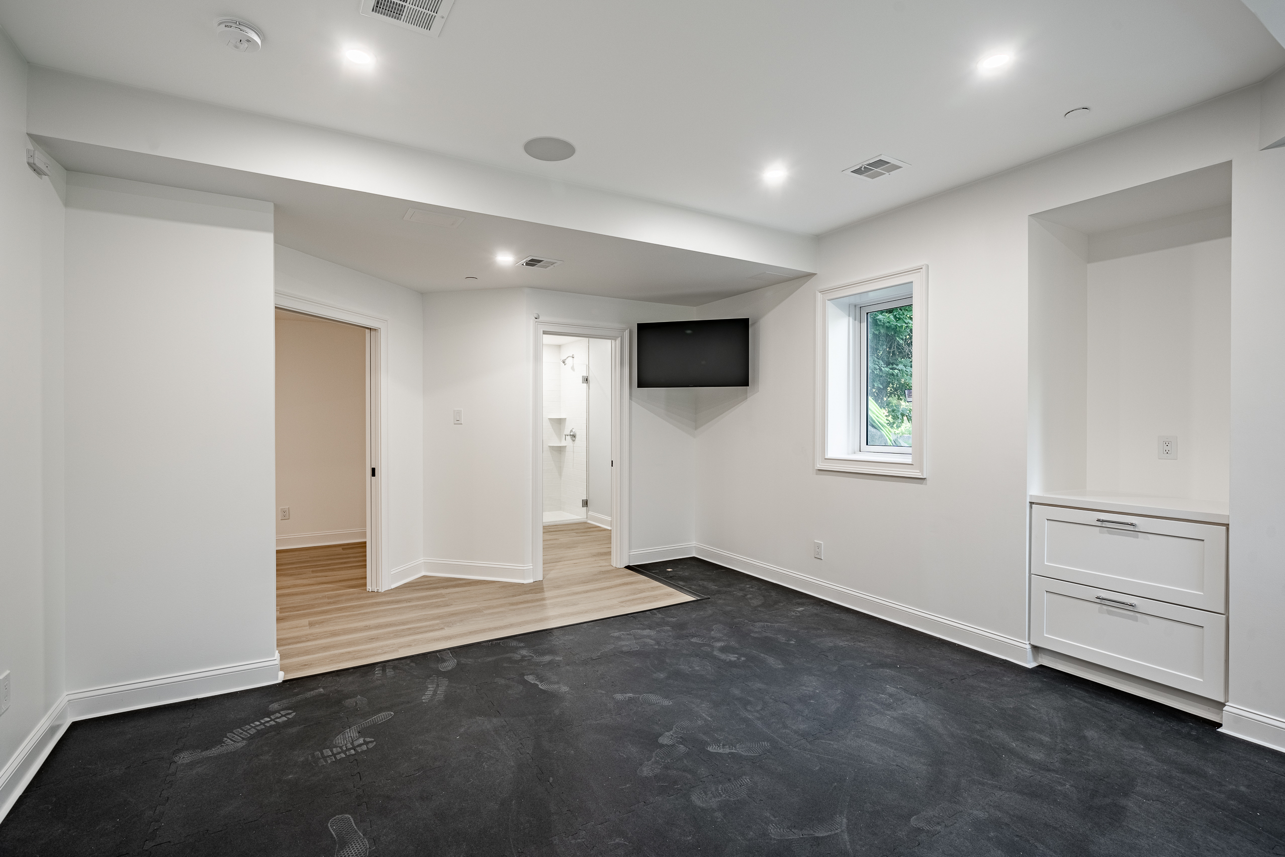 Newtown Square basement exercise room - gym area with doorway to main basement