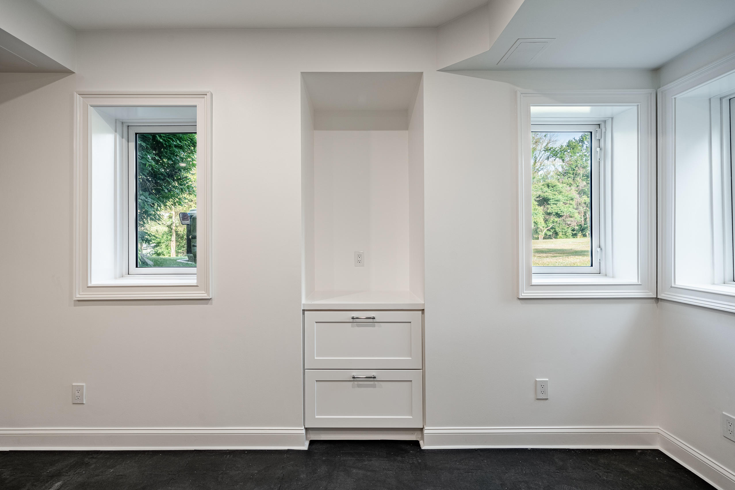 Newtown Square gym room - built-in storage with windows and natural light