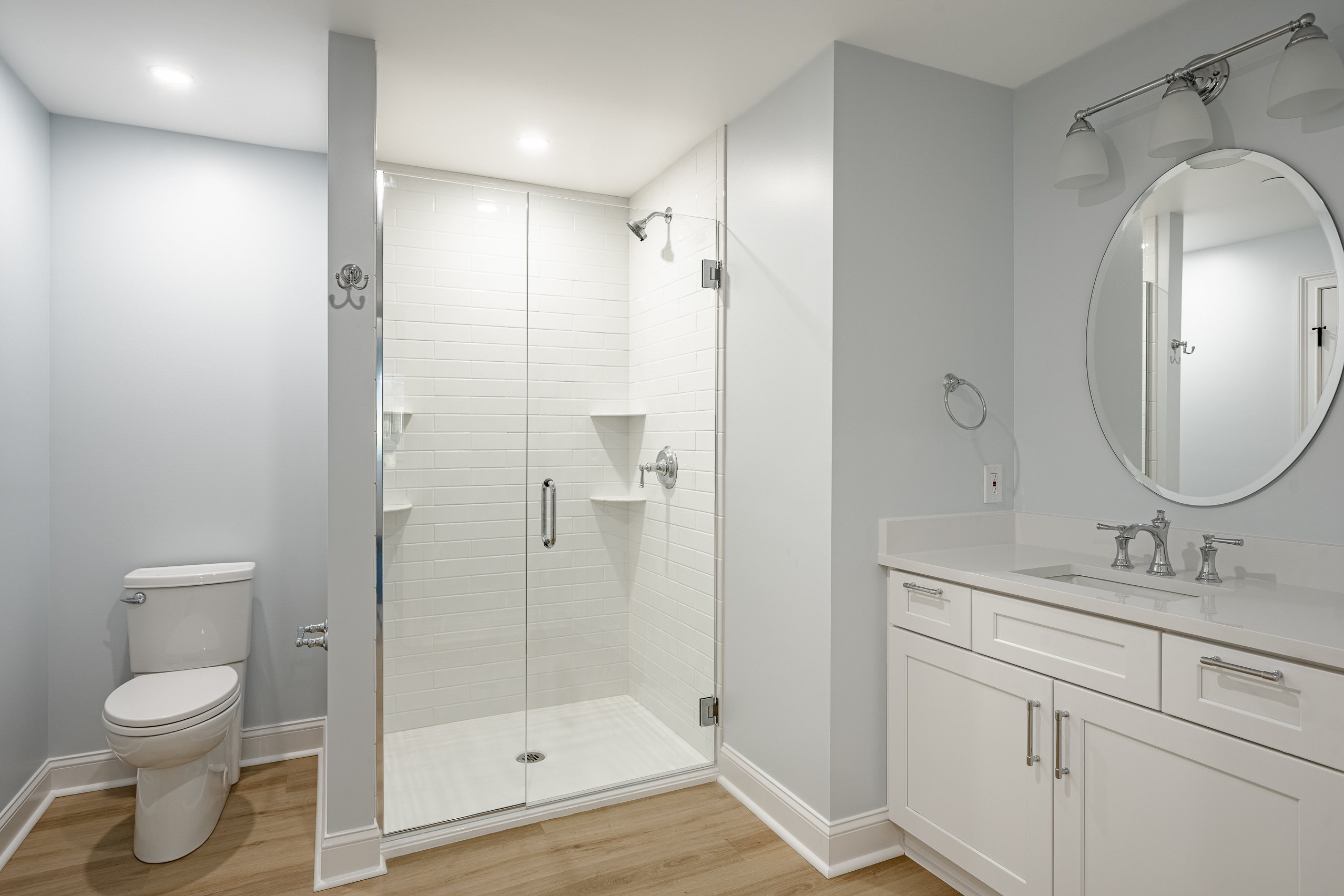 Newtown Square basement bathroom - glass shower with white subway tile and vanity