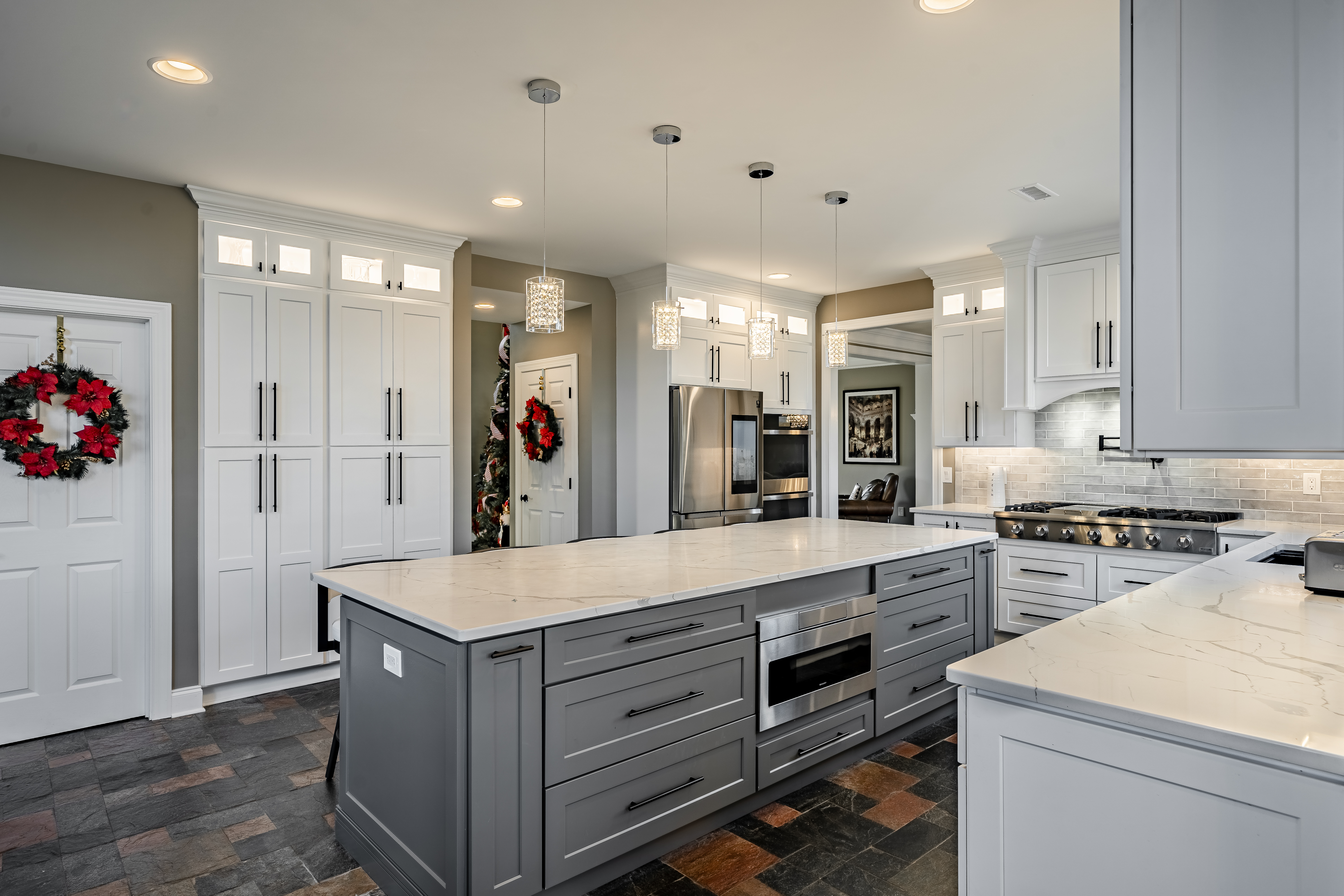 West Brandywine kitchen - charcoal gray island with built-in microwave drawer, floor-to-ceiling pantry cabinets, and pendant lighting