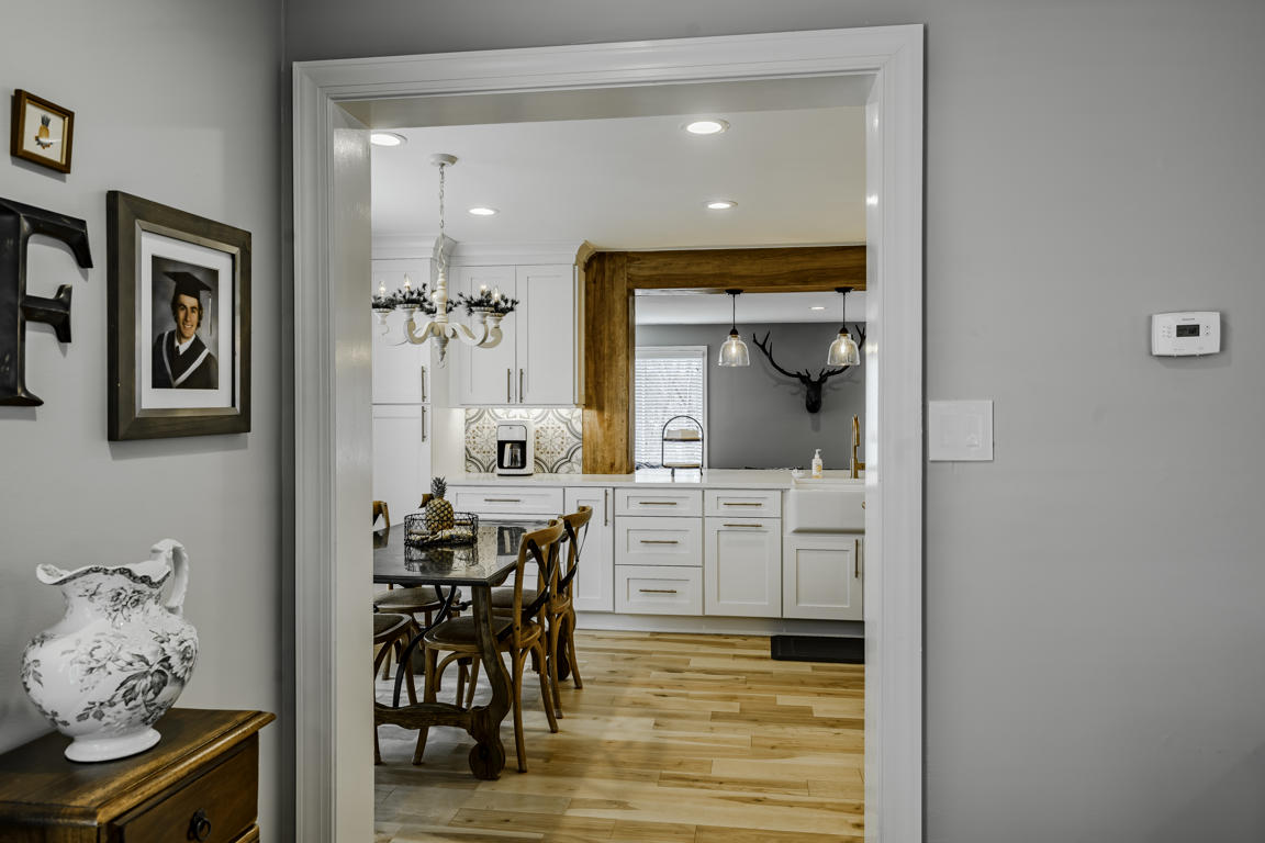 Kitchen counter detail with brass faucet, quartz surface, and decorative cement tile backsplash pattern close-up