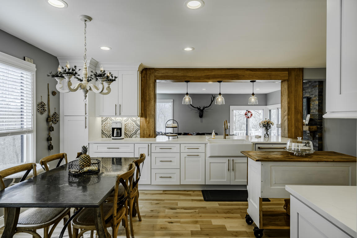 Kitchen cabinet hardware detail - brushed brass knobs on white shaker doors with quartz countertop edge profile