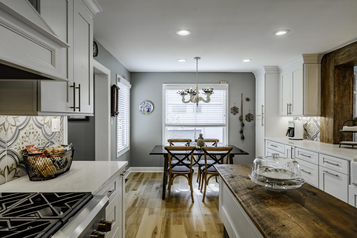 Kitchen and family room connection showing exposed wood beam and post framing the transition between spaces