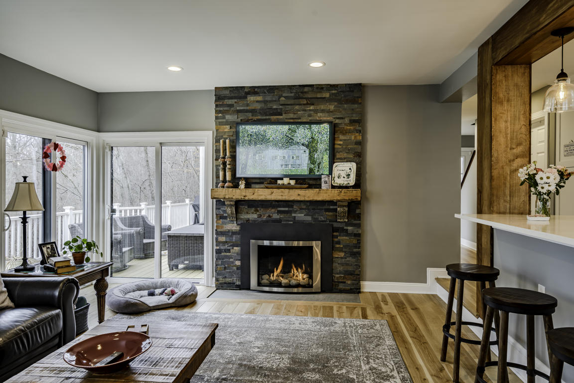 Kitchen drawer and cabinet detail with soft-close brass hardware on white shaker doors and quartz surface above