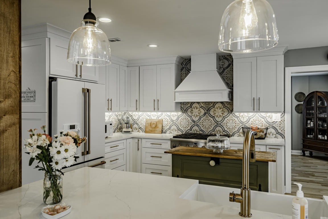 Family room with leather sectional, plaid accent chair, industrial coffee table, and antler wall mount