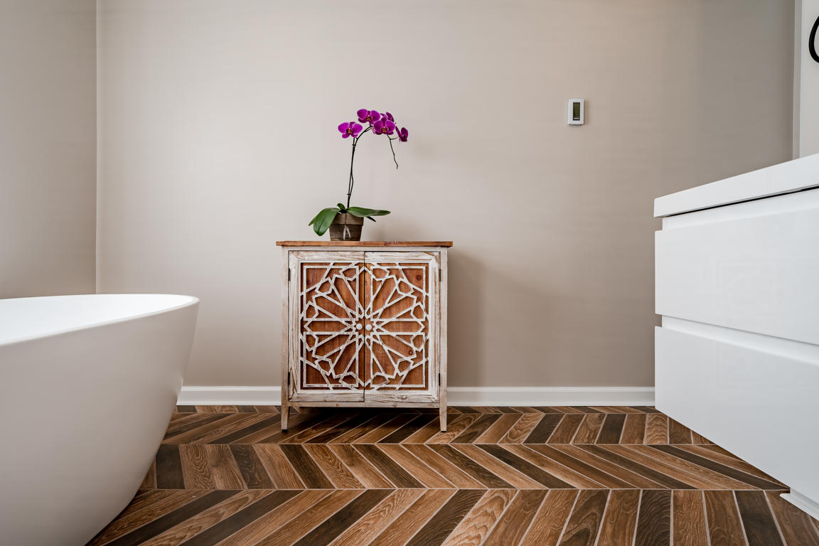 Moroccan fretwork accent cabinet close-up showing intricate geometric door pattern between tub and vanity