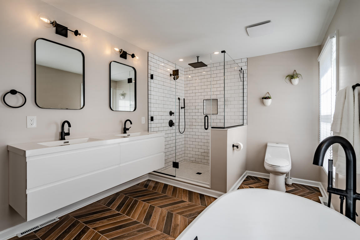 Soaking tub corner with artisan Moroccan-inspired fretwork accent cabinet, live orchid, and warm greige walls