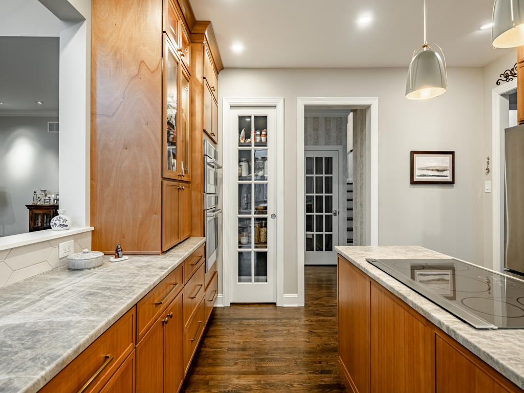 Custom 8-foot French door pantry with full glass lites beside Café double wall oven tower in West Chester kitchen remodel