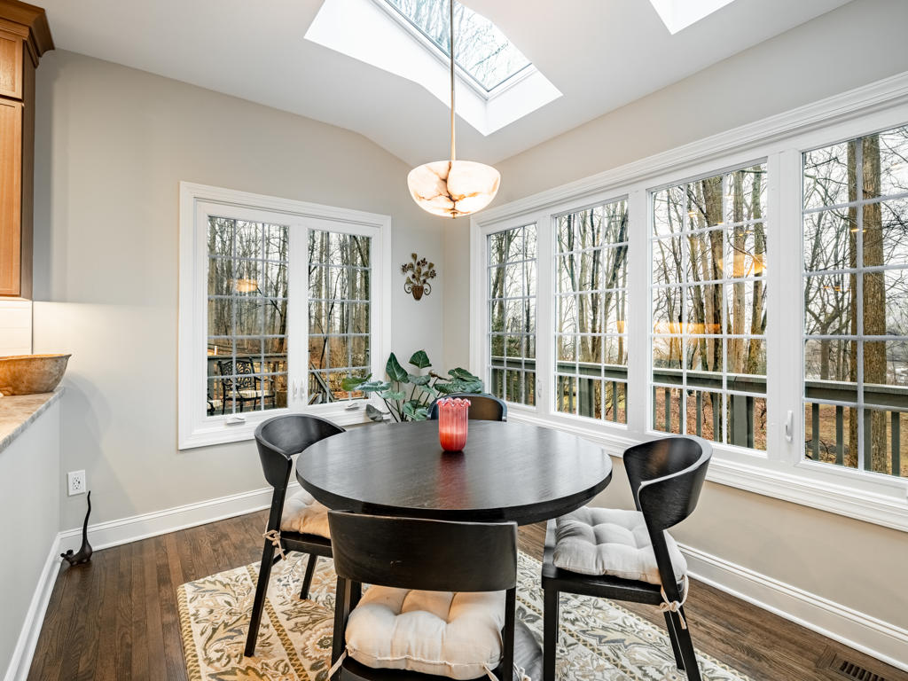 Light maple shaker upper cabinets to ceiling with under-cabinet lighting, brushed bronze round knobs, and elongated picket tile backsplash in West Chester PA kitchen