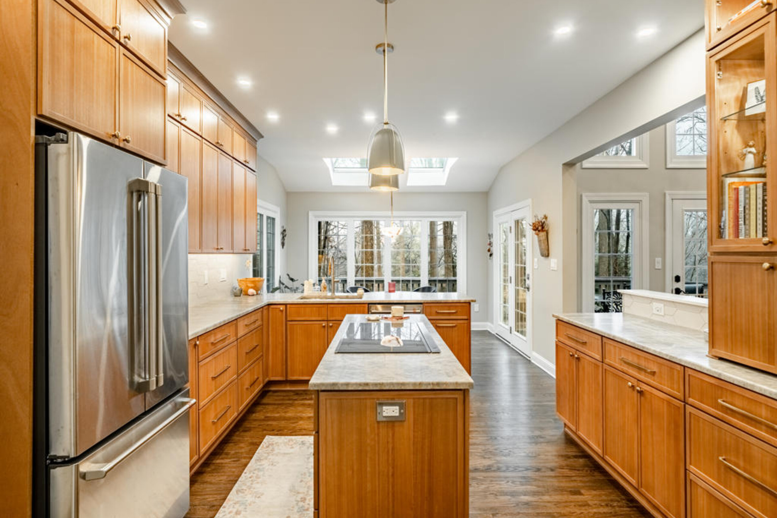 West Chester PA kitchen remodel with leathered quartzite countertops, light maple shaker cabinetry, and twin skylights