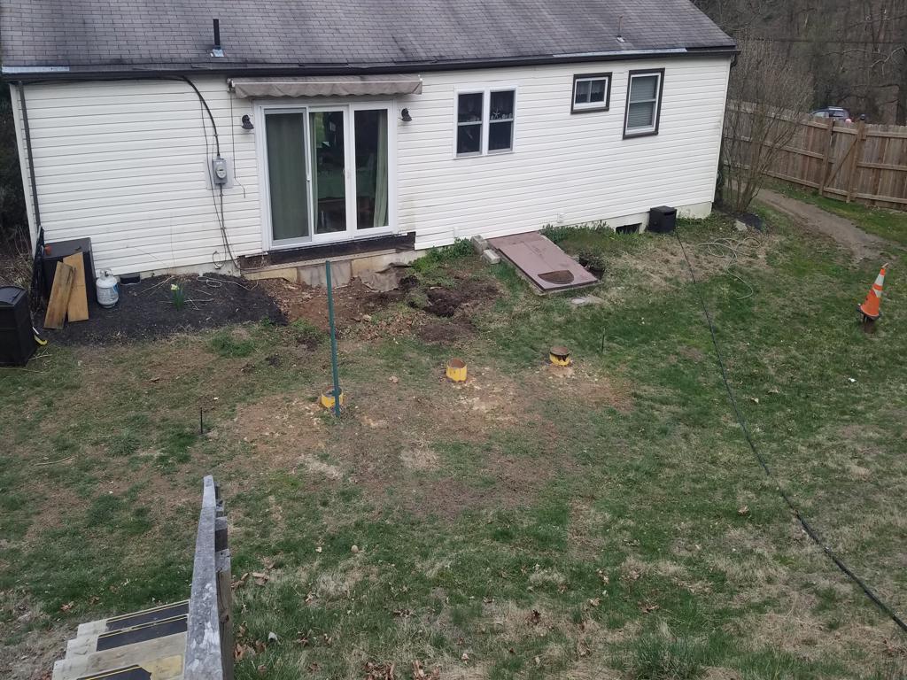 Rear yard before renovation with old deck removed