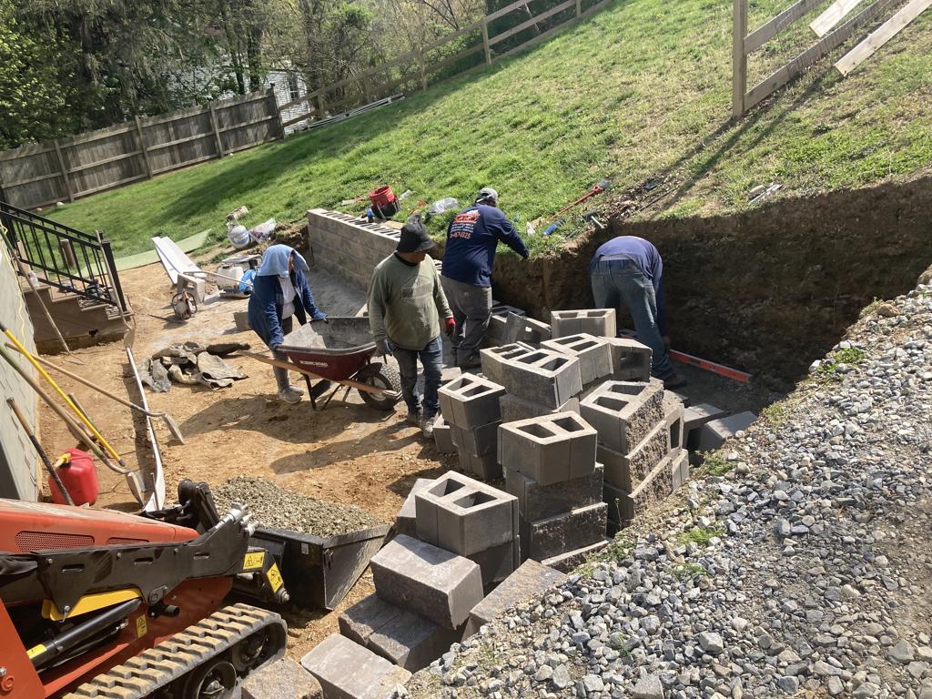 Crew building concrete block retaining wall