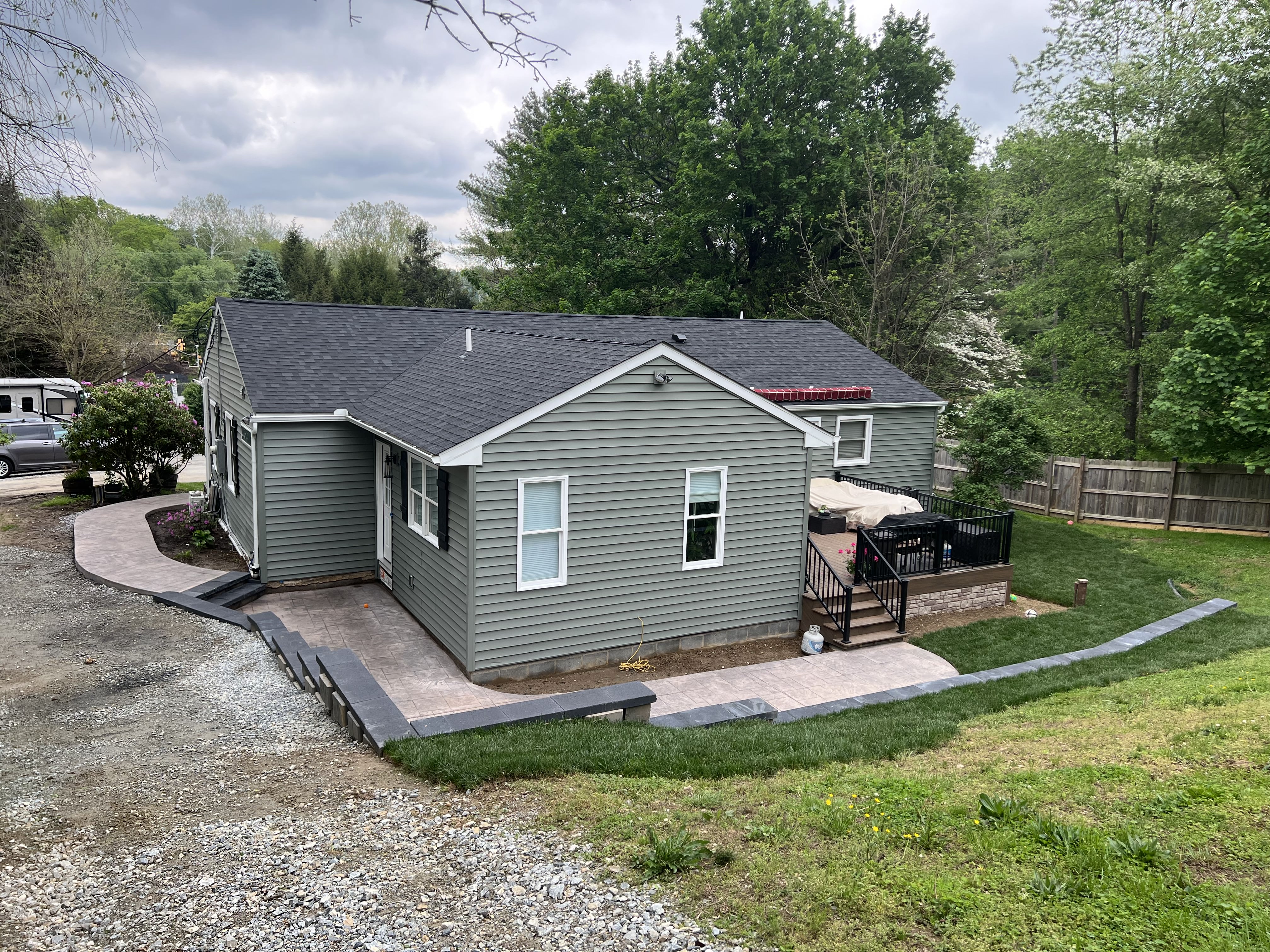Rear aerial view showing retaining walls and landscaping