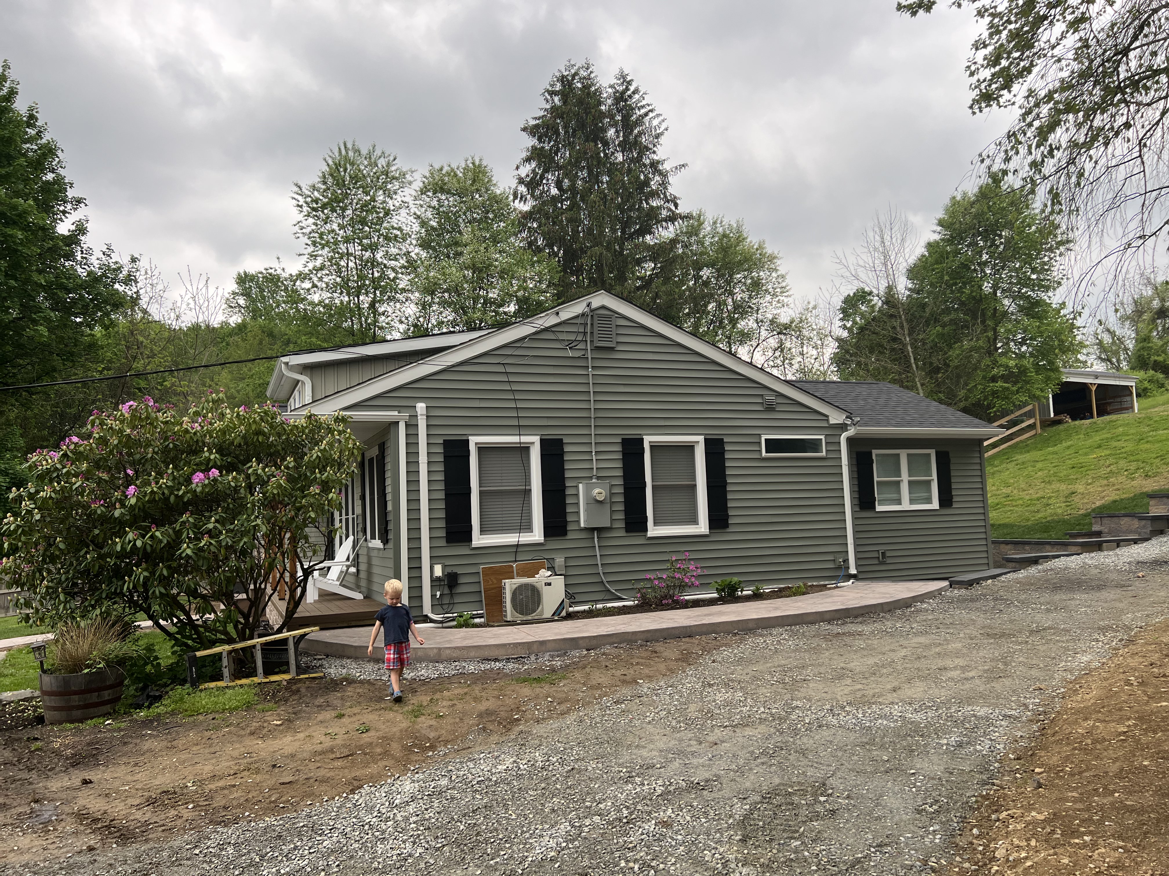 Side view showing new siding and stamped concrete