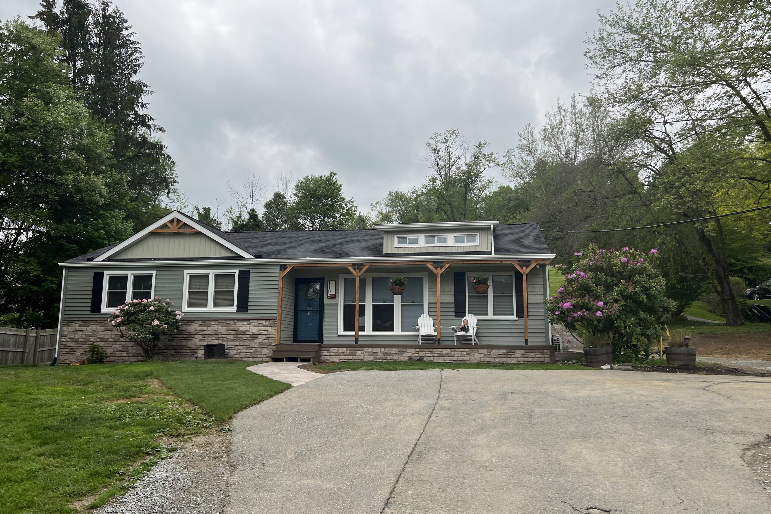 Completed Craftsman-style home exterior remodel in West Chester PA with stone veneer porch and new siding